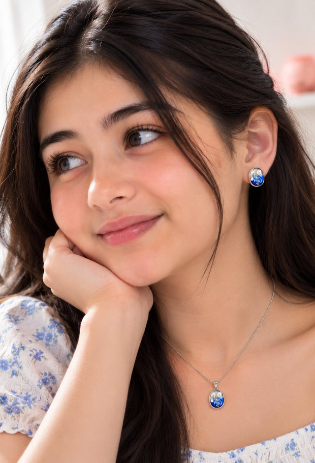 Close-up of the Blue Rose Pearl pendant and earrings worn by a model