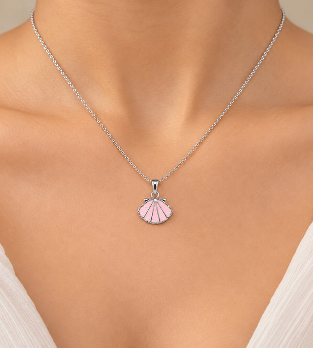 Close-up of the pink enamel shell fan pendant worn on the neck