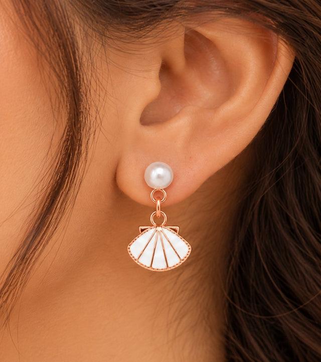 Close-up of the white enamel shell fan drop earring with a pearl