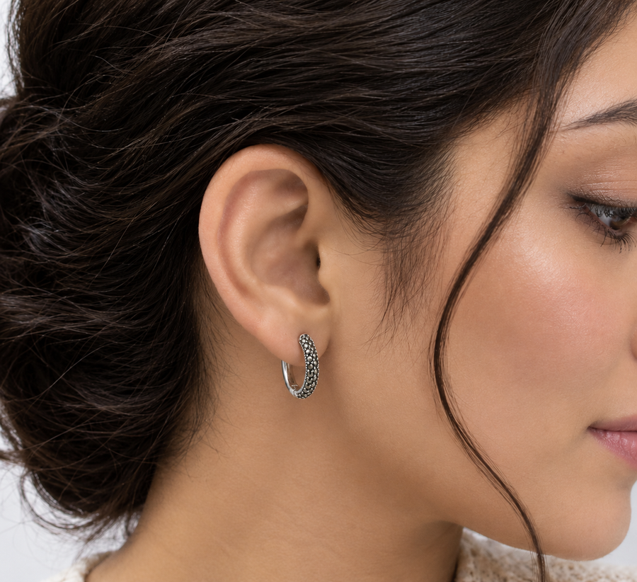 Model wearing Midnight Marcasite Huggie Earrings