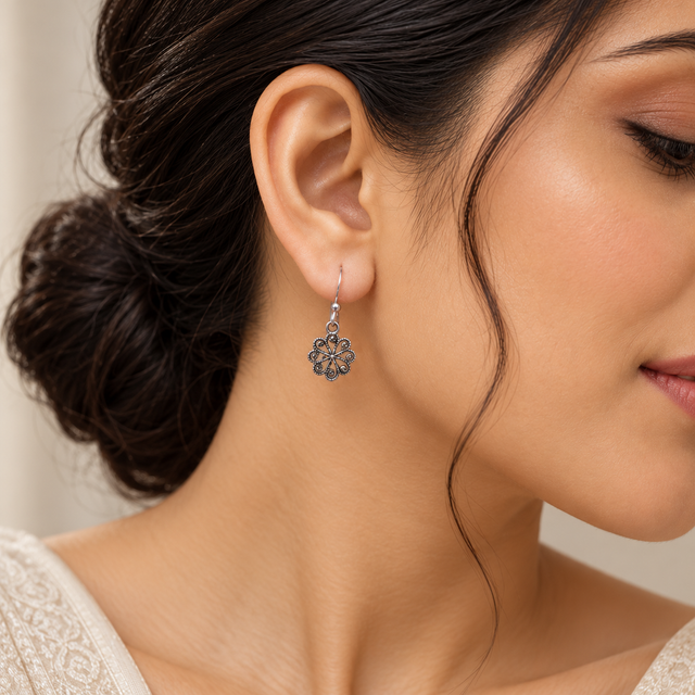 Model wearing Oxidised Silver Floral Charm Earrings