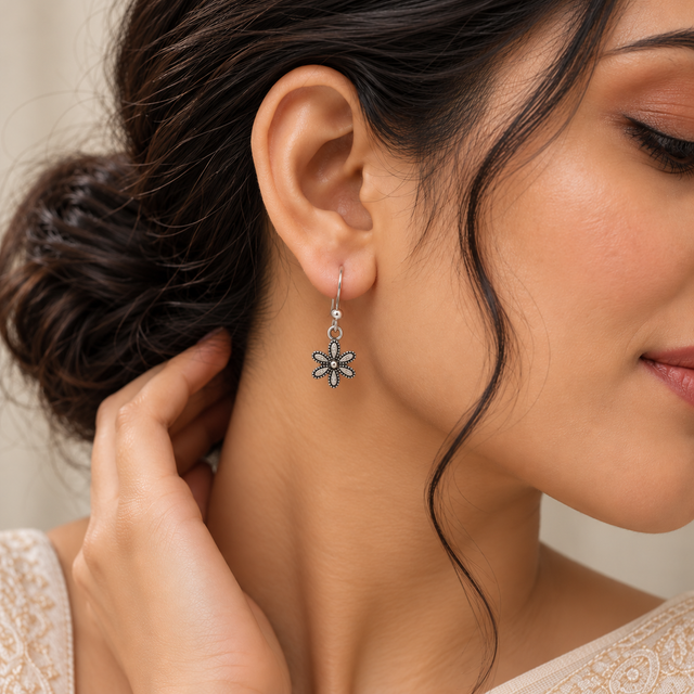 Model wearing Oxidised Silver Petal Charm Earrings
