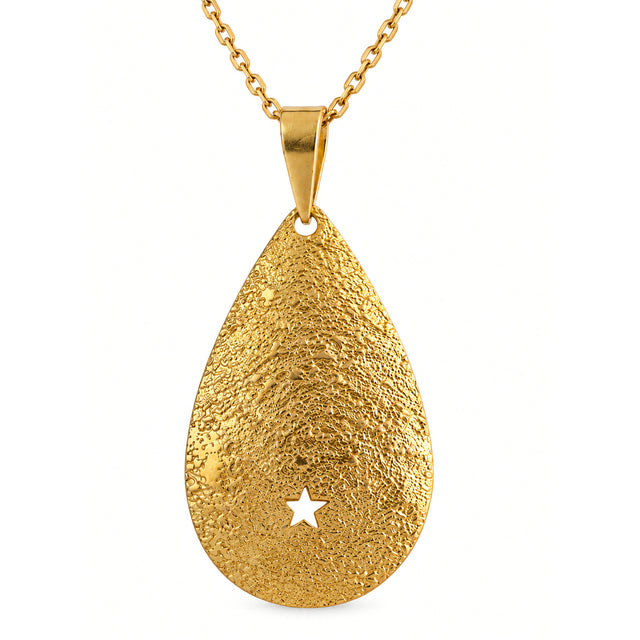Close-up of the textured gold teardrop pendant and its star cutout